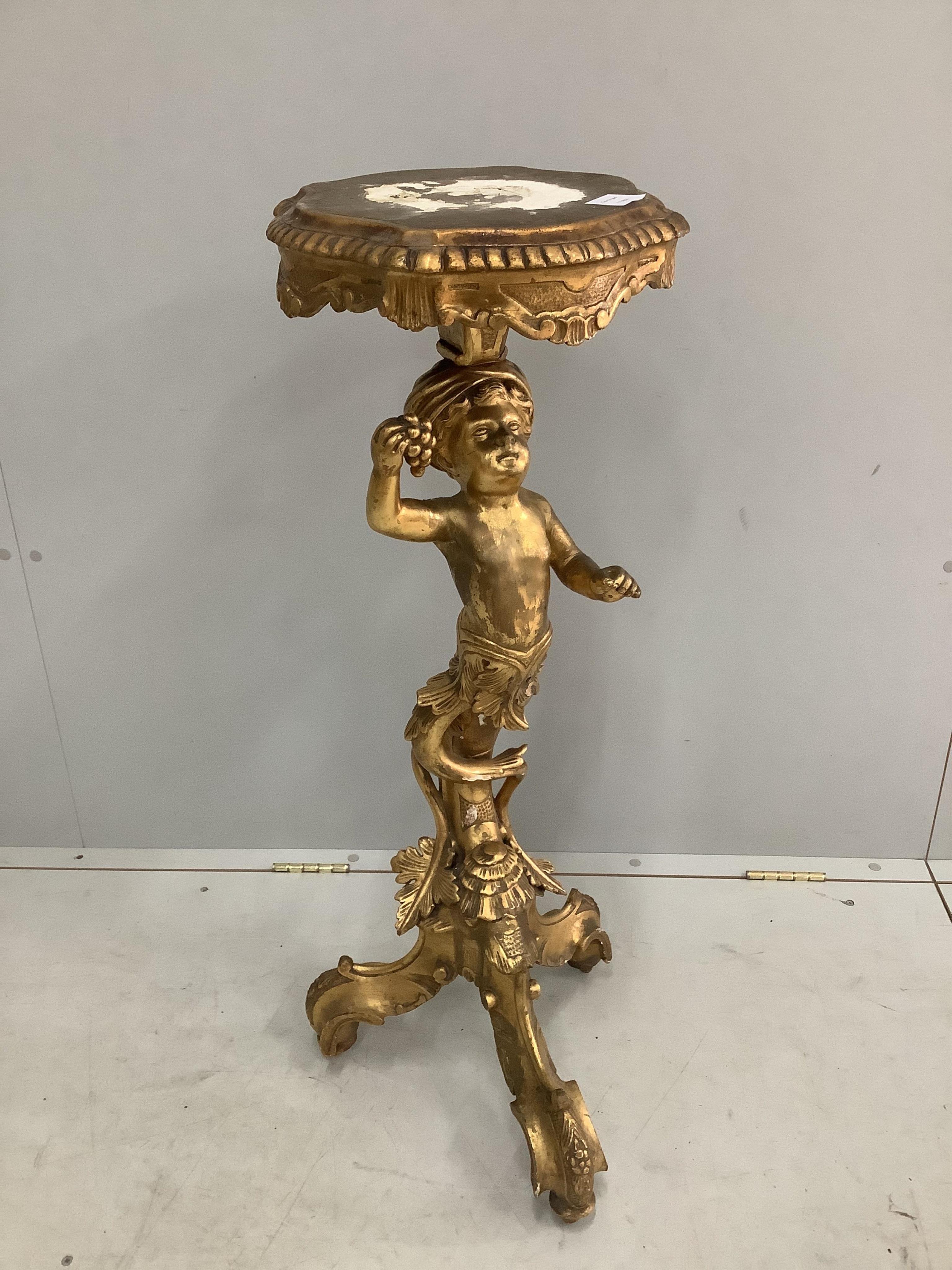 A carved giltwood and gesso figural torchere, height 95cm. Condition - fair